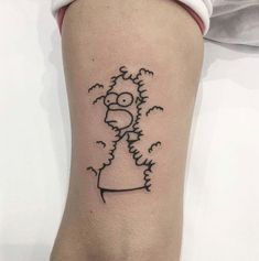 a woman's foot with a black and white cartoon character tattoo on the ankle