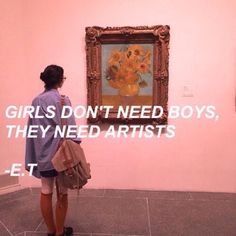 a woman standing in front of a painting with the words girls don't need boys, they need artists