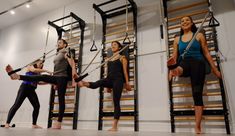 a group of people standing around each other in front of a set of ladders