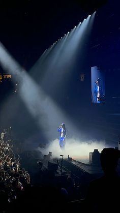 a person on a stage doing tricks in front of a crowd