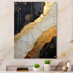 an abstract painting with gold and black colors on a white wall above a fireplace mantel