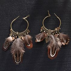 Bohemian style feather hoop-drop earrings really make a statement. A beautiful accent piece to any outfit for an added rustic look. Details Item Type: Fashion Earrings Metal Type: Copper Alloy,Feather Size: 11.6*4cm Back Finding: Saddleback Bohemian Brown Hoop Earrings For Festival, Bohemian Brown Dangle Hoop Earrings, Brown Bohemian Dangle Hoop Earrings, Bohemian Brown Hoop Earrings, Brown Bohemian Hoop Earrings, Bohemian Feather Earrings For Festivals, Bohemian Dangle Feather Earrings, Bohemian Dangle Earrings With Feathers, Bohemian Brown Feather Jewelry