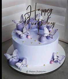 a birthday cake with purple butterflies on it