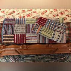 a close up of a couch with many different colored pillows on it's back