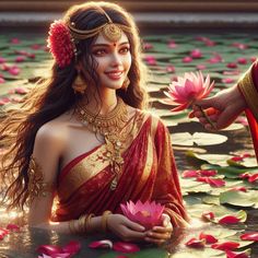 a woman in a red and gold sari sitting on top of water lilies