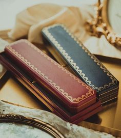 two books sitting on top of a table next to a pocket watch and other items