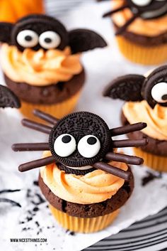 chocolate cupcakes decorated with orange frosting and googly eyes