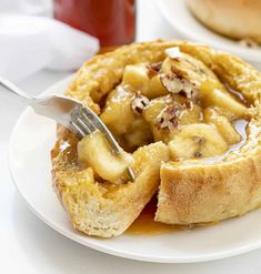 a white plate topped with french toast covered in syrup