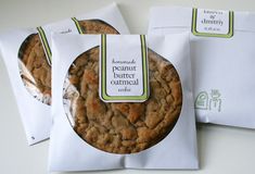 three bags of cookies sitting next to each other on top of a white countertop