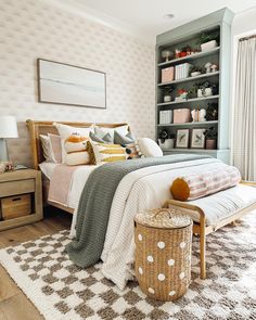 a bedroom with a bed, nightstands and bookshelf