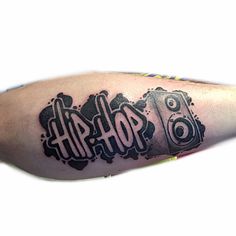 a man with a tattoo on his arm has the word hip written in black ink