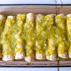 a pan filled with chicken covered in green sauce