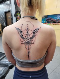 a woman with a tattoo on her back