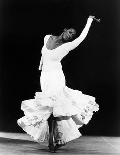 a black and white photo of a woman dancing