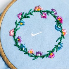 the hoop is made up of flowers and has a white nike logo on it's side