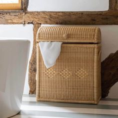 a basket sitting on the floor next to a toilet