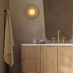 a bathroom with a sink, mirror and towel rack