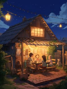 some people are sitting at a table in front of a house with lights strung from the roof