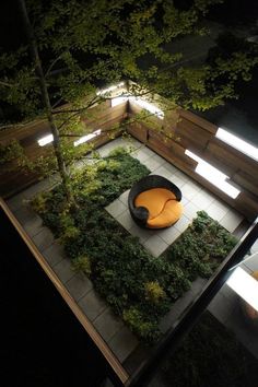 an outdoor seating area is lit up at night with lights shining on the ground and trees in the background