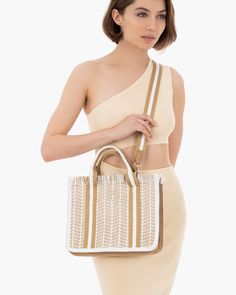 A mid-size shopper of woven raffia straw and canvas packs flat for travel. This women’s designer tote for sale incorporates sturdy cotton twill webbing handles and a detachable crossbody strap. Other design features include self-fringe top edge, zip top closure and two outside pockets, which provide easy access to cellphone and sunglasses. The interior has a sidewall zipper compartment and two patch pockets. All Eric Javits bags are lightweight and durable. Height: 10", length: 12”, width: 4.75” Eco-friendly Straw Beach Bag With Adjustable Strap, Eco-friendly Straw Beach Bag With Top Carry Handle, Eco-friendly Woven Beach Bag With Double Handle, Luxury Handwoven Eco-friendly Beach Bag, Eco-friendly Rectangular Beach Bag With Top Carry Handle, Fringe Top, Designer Totes, Woven Raffia, Raffia Bag