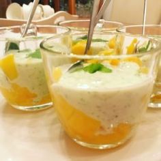 four glasses filled with food on top of a table