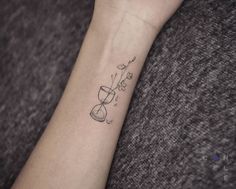 a woman's arm with a small tattoo on it