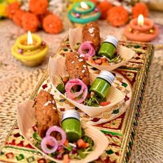 small plates with food on them sitting on a table next to candles and other decorations