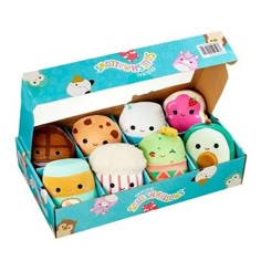 an assortment of stuffed animals in a box