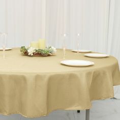 a table with plates and candles on it