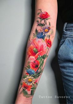 a woman's arm with flowers painted on it