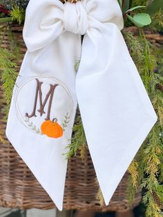 "Decorate your front door with a  wreath sash.   This wreath has the elegant monogram in beautiful fall colors framed with a pumpkin embroidery. Our sashes can be customized for any season with a variety of colors.  Sash will feature the pumpkin frame monogram on one tail.    *Sashes come in three lengths, 44\" , 54\" , 74\" *5\" width *Machine Washable *linen These are perfect for baby decor, basket decor, and so much more." Fall Applique Designs, Wreath Sashes, Thanksgiving Embroidery, Fall Applique, Wreath Sash, Pumpkin Embroidery, Purple Petunias, Personalized Home Decor, Basket Decor