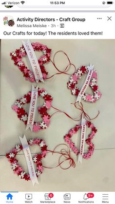 a group of red and white flowers on top of a table next to each other