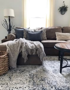 a living room filled with furniture and pillows