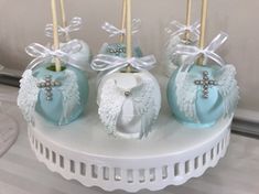 blue and white cake pops decorated with angel wings