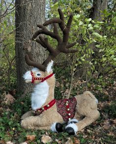 a stuffed deer is sitting in the woods