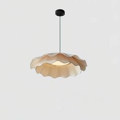 a light that is hanging from the ceiling in front of a white wall and floor