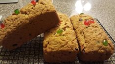 three pieces of cake sitting on top of a cooling rack