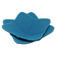 two blue hats are sitting on top of each other, one is folded and the other has