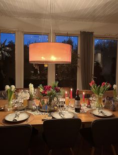 a dining room table is set with plates and place settings for four people to eat