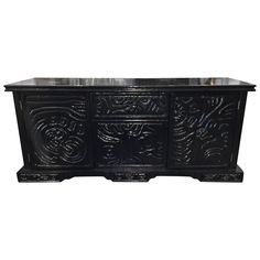 an ornately carved black cabinet with two doors