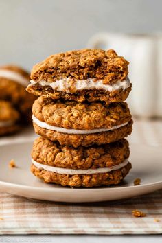 three oatmeal cookies stacked on top of each other with icing in the middle