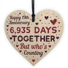 a wooden heart with the words, happy 10th anniversary and 350 days together but who's counting?