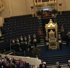 an image of a ceremony in the middle of a room with people sitting on chairs