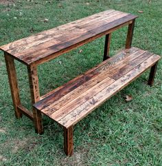 a wooden bench sitting on top of a lush green field