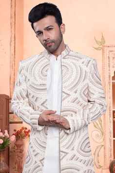 The U2-S404 Sherwani is the perfect combination of traditional and modern. Its open jacket design is adorned with intricate thread, stone, and sequin embroidery for a trendy, yet classic look. Make a statement at any event with this unique and stylish piece. Bollywood Style Outerwear With Chikankari Embroidery For Wedding, Traditional Blazer With Resham Embroidery For Festive Occasions, Bollywood Style Outerwear For Eid Wedding, Traditional Festive Blazer With Resham Embroidery, Festive Traditional Blazer With Resham Embroidery, Festive Traditional Designer Blazer, Festive Traditional Blazer With Zari Work, Festive Traditional Zari Work Blazer, Traditional Embroidered Blazer For Reception