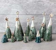 a group of ceramic christmas trees sitting next to each other