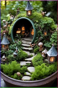 a potted planter filled with lots of green plants and small fairy houses in it