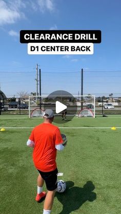 a man in an orange shirt and black shorts playing soccer on a field with the words clearance drill d1 center back