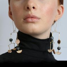 Our gorgeous mobile hanging earrings showcase a unique and stunning design. Where you can see different arrangements and cuts of gemstones being shown off in a unique manner. These hanging earrings are manufactured using top quality materials that have show a unique and quality design. Allowing you the chance to show off the perfect union between leather and goldfield. As each aspect of the design comes forward beautifully, showing off a gorgeous piece that you would simply fall in love with Hipster Purse, Mobile Hanging, Abstract Earrings, Earrings Geometric, Hanging Earrings, Earrings Drop, Everyday Earrings, Geometric Earrings, Gold Plated Earrings