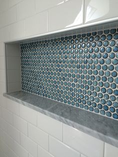 a bathroom with blue and white tiles on the wall